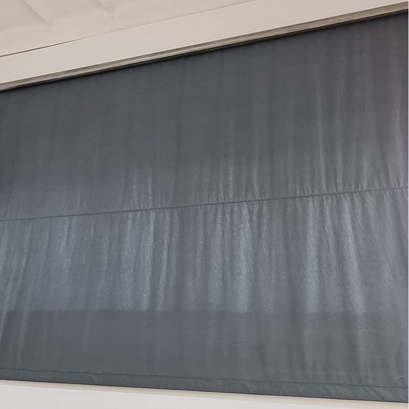 Roller shutter system for winding blackout curtains with electric drive